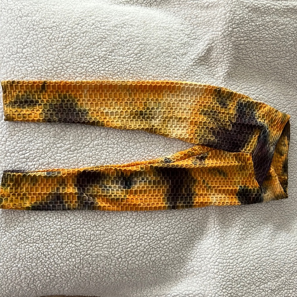 Orange and grey tie-dye stretchy yoga pants with a scrunch style on the butt.